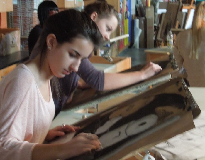 Advanced Art students working on a charcoal still life